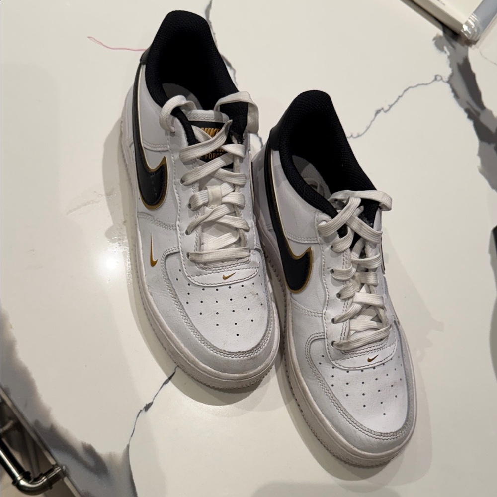 Nike boys White and Black Sneakers with Gold Accents